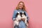 Caucasian woman holding and comforting two pet dogs japanese chins.