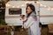 Caucasian woman hugging with Jack Russell Terrier dog outdoors. Travel in a camper in autumn.