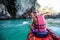 Caucasian woman is kayaking in sea