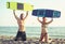 Caucasian woman kitesurfer enjoying summertime on sandy beach with her boyfriend.