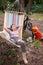 Caucasian woman lies in a hammock in a pine forest