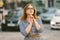 Caucasian woman and light bulb with bokeh background. street style fashion. European trip, old city, summer vacation. happy