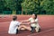 Caucasian woman and little girl are engaged in fitness at the stadium.