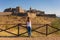 Caucasian woman looking at Juromenha castle on a summer day in Alentejo, Portugal