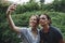 Caucasian woman and man taking a selfie outdoors recreational leisure, freedom and adventure concept