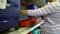 Caucasian woman near shop shelves choosing suitcase in haberdashery market