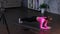 Caucasian woman practicing workout exercises at home while doing plank, using mobile phone and camera on tripod. Home