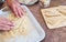 Caucasian woman prepare food for lunch, fish fillets. Senior people in domestic kitchen