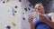 Caucasian woman preparing her hands with chalk before climbing at indoor climbing wall