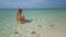 Caucasian woman relaxing in tropical sea with starfish, Phu Quoc Island, Vietnam