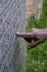 Caucasian woman`s hand pointing at a gravestone, Dumfries and Galloway