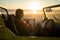 Caucasian woman sitting in beach buggy by the sea during sunset