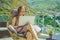 Caucasian woman sitting on the terrace working from home using computer laptop. Young woman teaches a foreign language