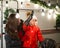 Caucasian woman and son decorate camper for christmas. Happy family travels in a mobile home.