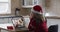 Caucasian woman spending time at home wearing santa hat