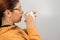 Caucasian woman spilled hot coffee on herself on white background.