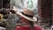 Caucasian woman in straw hat is walking among ruins of Ta Prohm