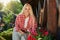 Caucasian woman taking care with of flowers outdoors