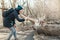 Caucasian woman taking picture photo of squirrel in park. Tourist traveler girl snapping smartphone photos of wild animal in a