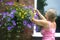 Caucasian woman tending to her flower basket