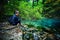 caucasian woman tourist relaxing by the river, in the forest, Ochiul Beiului, Romania