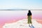 Caucasian woman tourist stand on Maharlu pink salt lake shore. Travel destination Iran in Shiraz