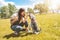 Caucasian woman trains and feeds her beloved schnauzer dog in the park. concept of love for animals. best friends