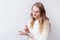 Caucasian woman uses hand sanitizer on the light background with copy space. quarantine, coronavirus, covid-19