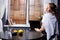 Caucasian woman using mock up screen laptop, making video call to conference partner, smiling looking at camera, work from home