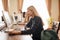 Caucasian woman using personal computer to browse the net in office library.