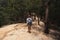 Caucasian woman walking with backpack down the mountain. Traveler going camping.