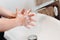 Caucasian woman washing and cleaning hands and fingers with soap and water