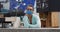 Caucasian woman wearing face mask leaning on counter at reception of indoor climbing gym