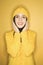 Caucasian woman wearing yellow raincoat.