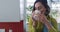 Caucasian woman wearing yellow shirt and drinking coffee