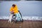 Caucasian woman in a wheelchair walks the dog in winter.