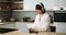 Caucasian Woman Working with Laptop in the Kitchen