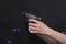 Caucasian women arms holding a gun against black background