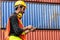 Caucasian worker in safety vest reflective with Safety helmet holding tablet and talking to radio reciever to checked about his