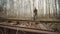 Caucasian worker switches arrows mechanism of tracks on the railway in autumn forest