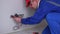 Caucasian worker testing wall socket