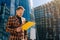 Caucasian young businessman reads the text on a tablet. The concept of a business man on the street