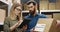 Caucasian young couple of male and female postal workers standing in mail store with carton boxes, talking and