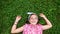 Caucasian young girl lying down on the grass in the park