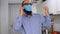 Caucasian young man with beard and in medical mask talking on mobile phone. Business man using smart phone.