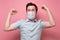 Caucasian young man holding fists up being happy with recovery wearing medical mask