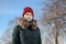 Caucasian young woman, 23 years old, with grey protective cotton mask on her face is outdoors