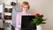 Caucasian young woman sits at laptop and types in cozy room.