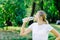 Caucasion woman thirsty and drinking water from pet bottle in public park