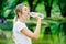 Caucasion woman thirsty and drinking water from pet bottle in public park